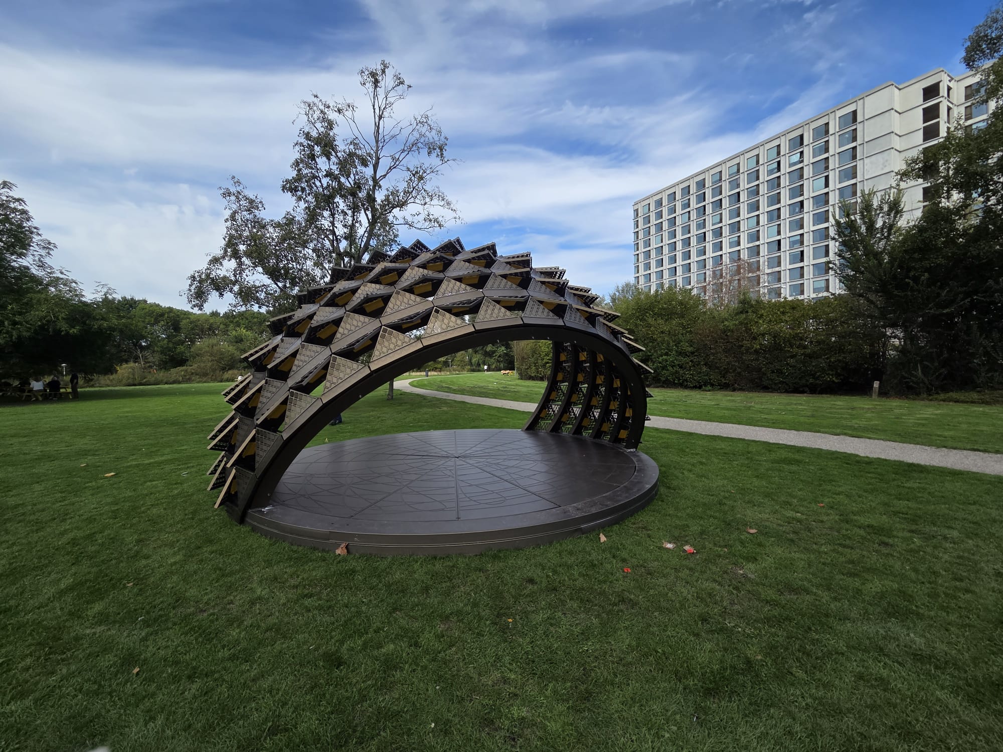 SOMBRA pavilion on the campus of Eindhoven University of Technology, surrounded by greenery and university buildings.